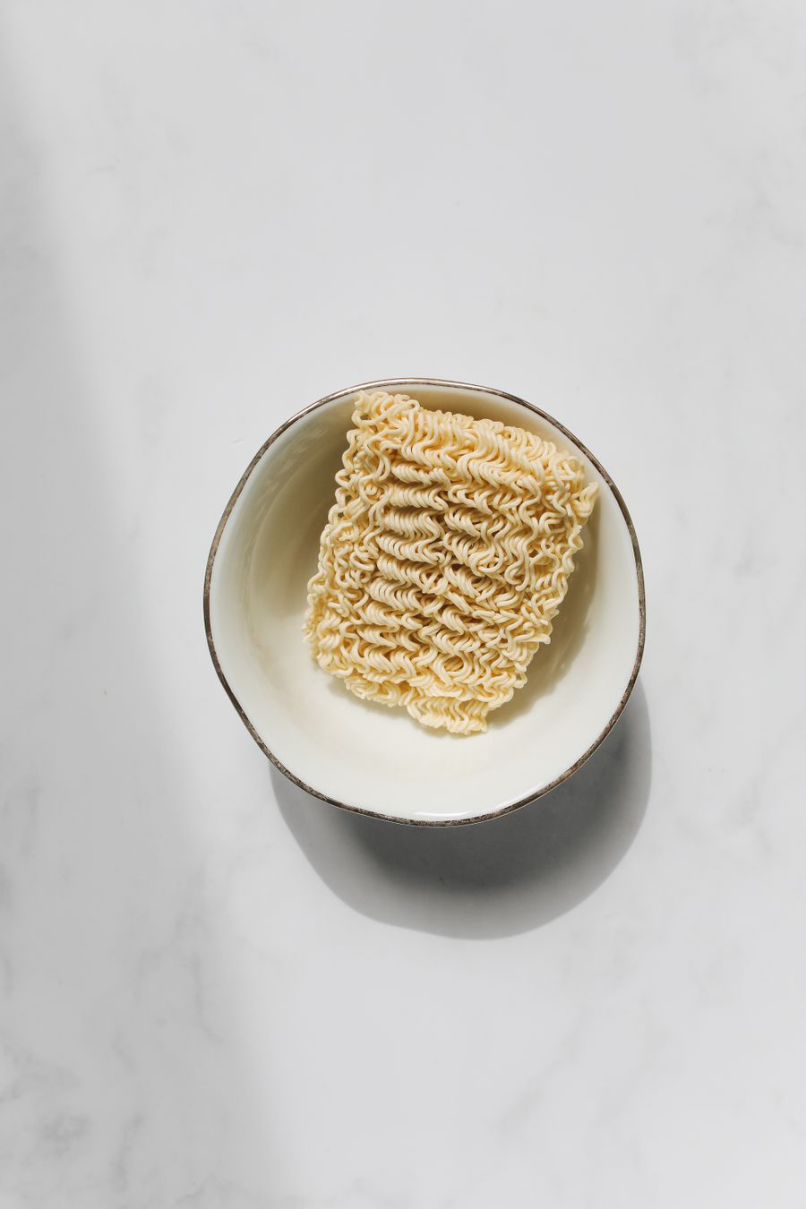 A block of instant noodles in a bowl